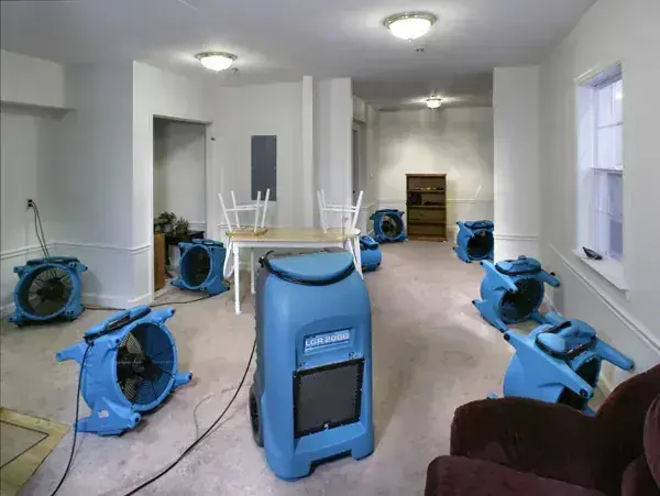 Air movers and a dehumidifier drying a Spring Hill home after a water loss