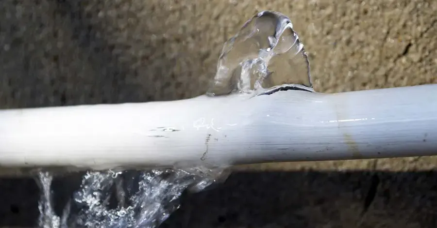 Water spraying from a split plastic supply pipe